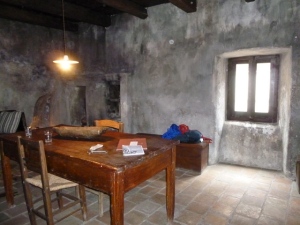 A rustic interior, furnished as it might have been hundreds of years ago.