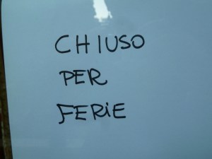 A simple hand-lettered sign on a boutique. When will they return? Who knows!