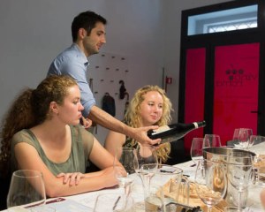 Maurizio shares wine and knowledge with two young Americans. Photo by Michael Horne.