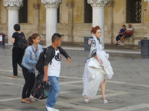 Bride readying for pictures in Piazza San Marco