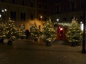 In a piazza, a forest of Christmas trees surrounds a little cabin where Babbo Natale hears the wishes of the bambini.