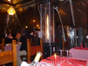 This is outdoor space in 3 season, but for winter, encased in a transparent plastic "tent" heated by flaming torches.