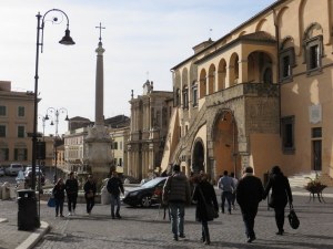 Classic Italian piazza": City Hall, a fountain, people enjoying a stroll.