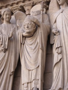 Saint Dennis holding his head, facade of Notre Dame. 