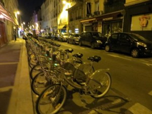 Velib bikes all tucked away at night. During the day the racks were empty, all bikes in use.