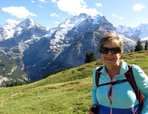 WOman in front of snowy mountains