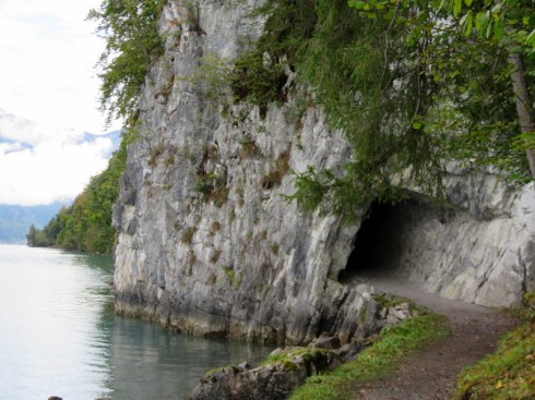 Tunnel through rock by lake