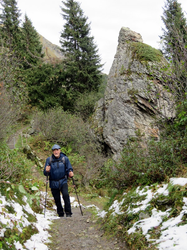 Man on trail with rocks in background
